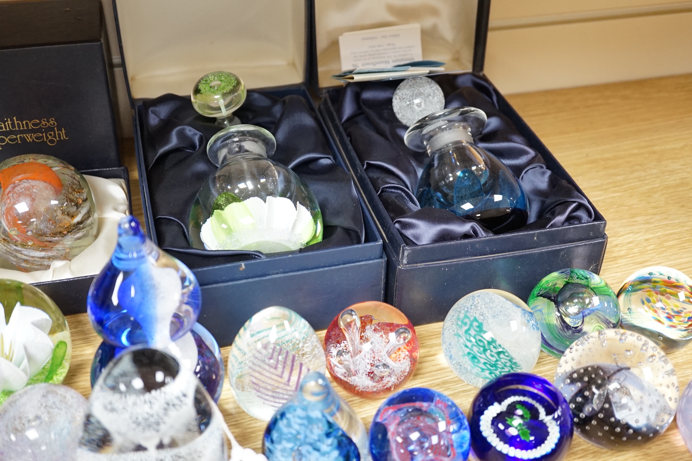 A collection of mostly Caithness glass paperweights, 1980s-2000s, with various boxes